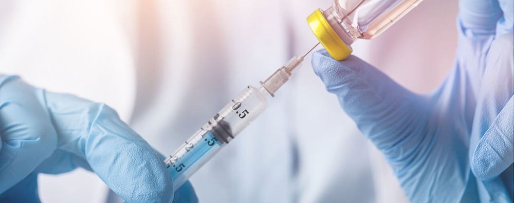 Scientist preparing a syringe from a vial