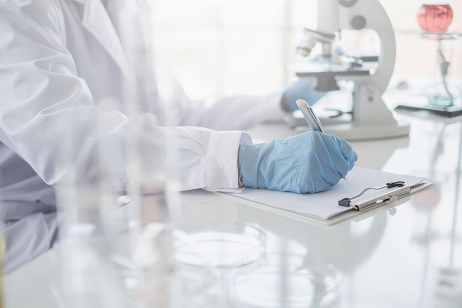 Scientist recording results at a bench
